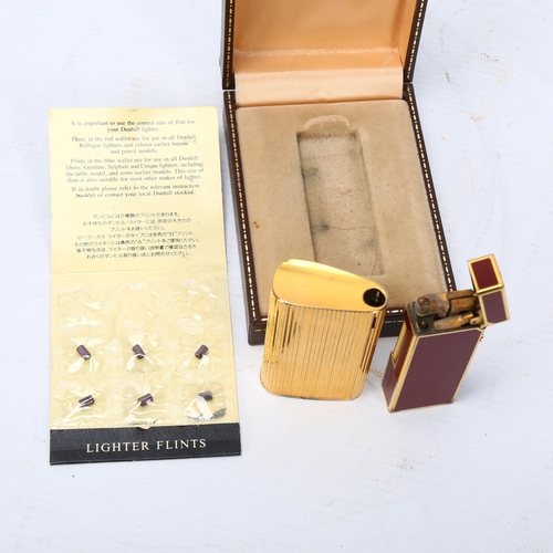 283 - Dunhill red enamel pocket lighter, boxed, and a Ronson gold plated pocket lighter (2)