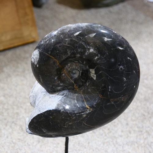 328 - A prehistoric fossilised goniatite on metal stand, height 50cm