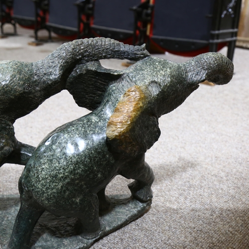 329 - An African green serpentine marble carved sculpture of 2 elephants, length approx 83cm