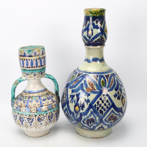 332 - 2 Middle Eastern Islamic pottery vases, with hand painted geometric decoration, largest height 35cm