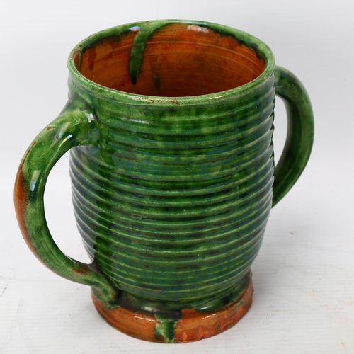 356 - Edwin Beer Fishley for Fremington Pottery Devon (1832 - 1911), a green glazed 2-handled loving cup, ... 