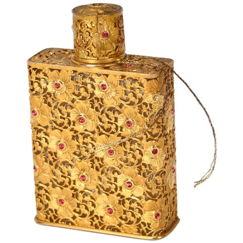 363 - Schiaparelli glass perfume bottle, with jewelled gilt-metal casing, height 6.5cm, original label