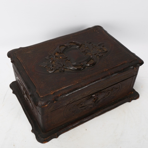 376 - A 19th century Black Forest lady's travelling box, relief carved wood, the interior fully fitted wit... 