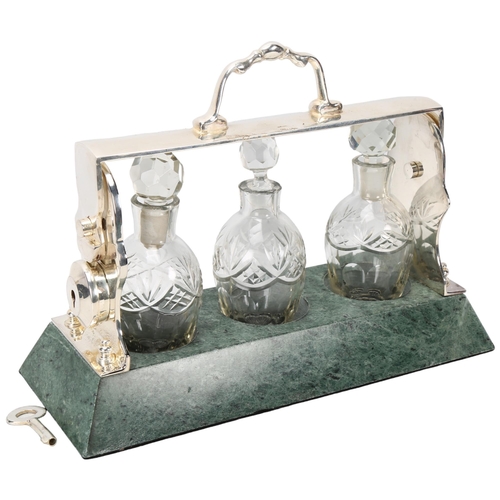 378 - A cut-glass and silver plate 3-bottle liqueur tantalus, on green marble base, length 26cm, and a rep... 