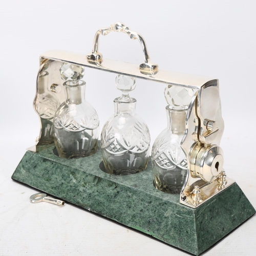 378 - A cut-glass and silver plate 3-bottle liqueur tantalus, on green marble base, length 26cm, and a rep... 