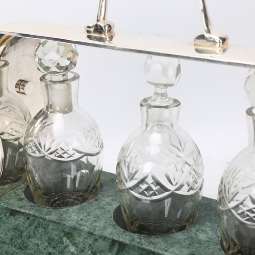 378 - A cut-glass and silver plate 3-bottle liqueur tantalus, on green marble base, length 26cm, and a rep... 