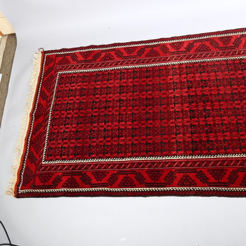 385 - Good quality Bokhara handmade red ground rug, 213cm x 122cm (7' x 4')