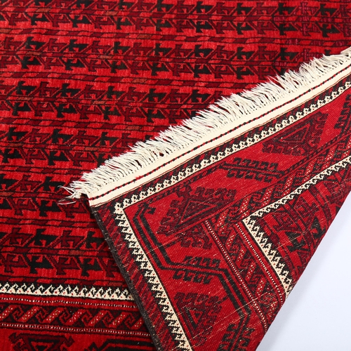 385 - Good quality Bokhara handmade red ground rug, 213cm x 122cm (7' x 4')