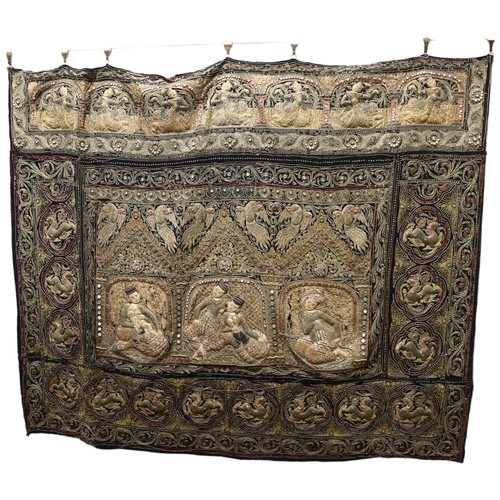 387 - A large Thai hand embroidered wall hanging, late 19th or early 20th century, with gold braid and jew... 