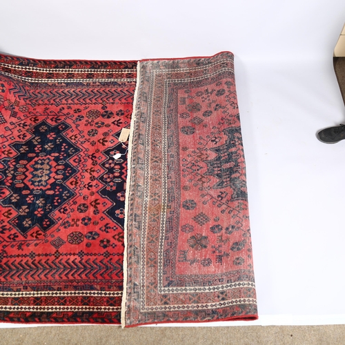 11 - A hand-made Kurdish red and blue ground geometric design rug, mid to late 20th century, 290 x 182cm