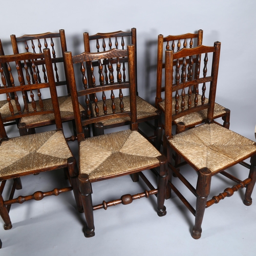 14 - A set of 10 (8 + 2) elm Lancashire spindle-back dining chairs, with rush seats, turned legs and pad ... 