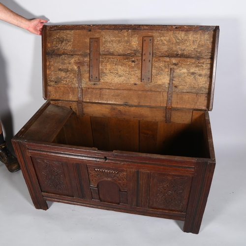 35 - A 17th century oak panelled coffer, with chip carved Archadian and linenfold panels, 120 x 54 x 66cm