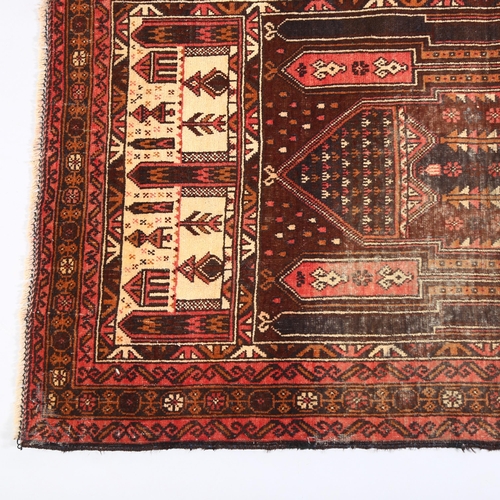 36 - A red ground Beluchi wool prayer rug, 135cm x 87cm