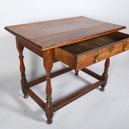 49 - A George II oak lowboy, with plank top, ring turned column legs and brass pear-drop handles, 87 x 54... 