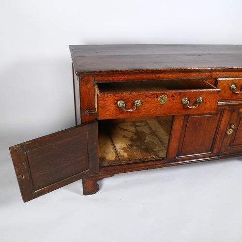 7 - An 18th century oak dresser base, with 2 frieze drawers, 2 fielded panelled cupboards under and blan... 