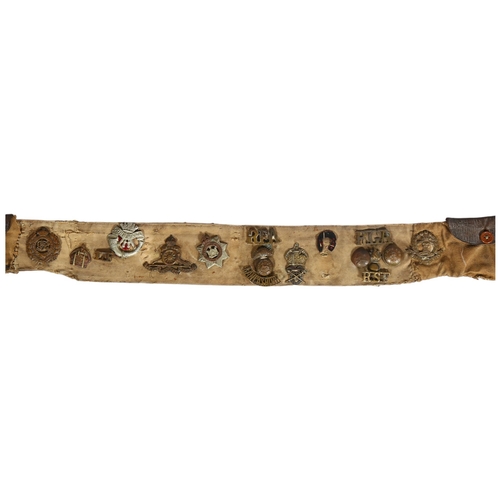 411 - A World War 1 British Army canvas belt with attached regimental badges