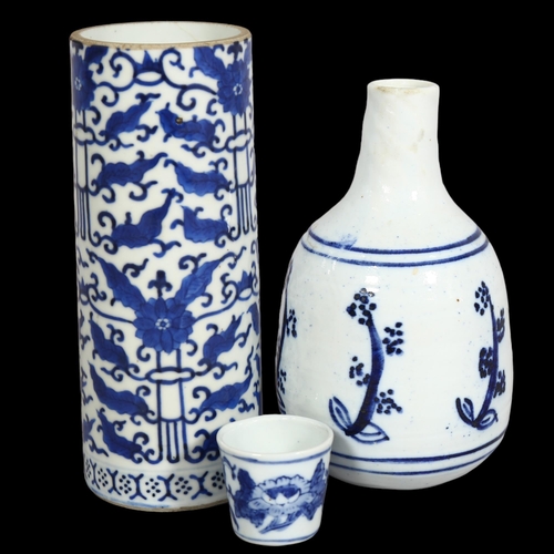 395 - 3 pieces of Oriental blue and white glazed ceramics, Chinese Cylinder vase and beakers with characte... 