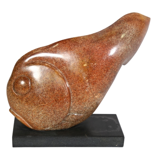 399 - A carved and polished red/brown granite fish on black granite base, length 33cm