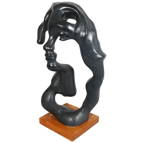 401 - A abstract sculpture of a face, composite patinated material, on wooden base, overall height 56cm