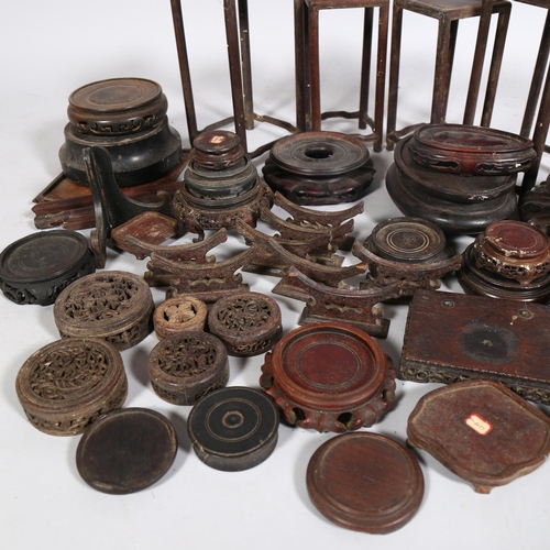 54 - A collection of Chinese hardwood carved stands and jar covers