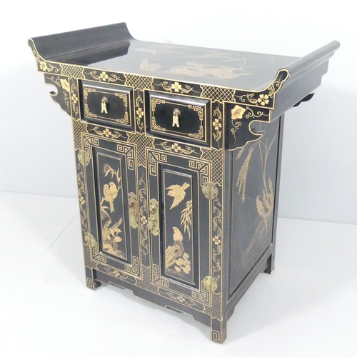 2005 - A contemporary Oriental black laquered altar cabinet, with gilt painted decoration, two drawers and ... 