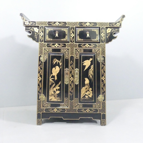 2005 - A contemporary Oriental black laquered altar cabinet, with gilt painted decoration, two drawers and ... 