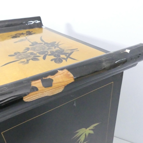 2006 - A contemporary Oriental black lacquered two door cabinet, with gilt painted and gold leaf decoration... 