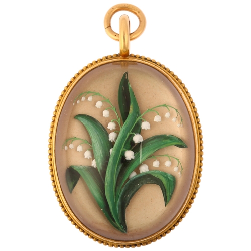 A late Victorian Essex Crystal 'Lily of the Valley' locket pendant, circa 1880, the oval high cabochon reverse carved intaglio glass depicting a hand painted floral spray, within an 18ct gold beaded frame, 40.7mm, 14.5g