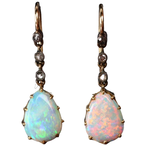 1113 - A pair of Edwardian opal and diamond drop earrings, the unmarked gold and silver settings with pear ... 