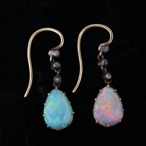 1113 - A pair of Edwardian opal and diamond drop earrings, the unmarked gold and silver settings with pear ... 