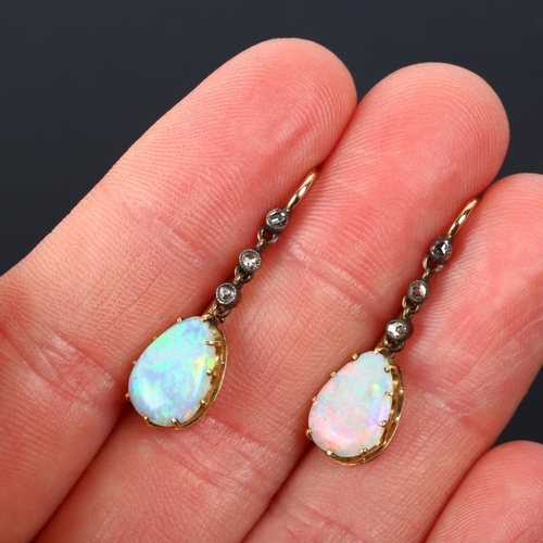 1113 - A pair of Edwardian opal and diamond drop earrings, the unmarked gold and silver settings with pear ... 