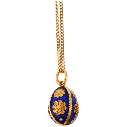 1127 - A Continental 18ct gold blue enamel egg pendant necklace, on 18ct fine curb link chain, the egg deco... 