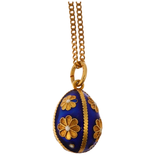 1127 - A Continental 18ct gold blue enamel egg pendant necklace, on 18ct fine curb link chain, the egg deco... 