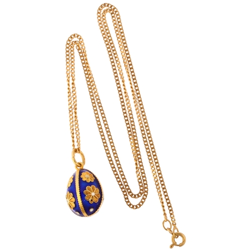 1127 - A Continental 18ct gold blue enamel egg pendant necklace, on 18ct fine curb link chain, the egg deco... 