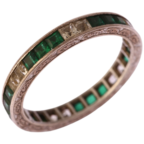 1134 - An Art Deco green and white paste full eternity ring, unmarked white metal settings with square-cut ... 