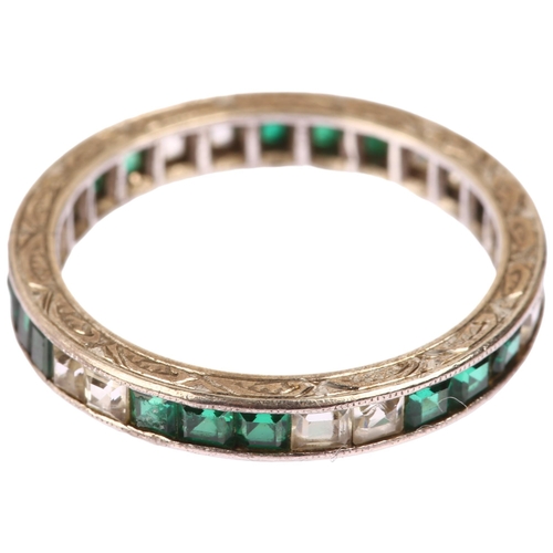 1134 - An Art Deco green and white paste full eternity ring, unmarked white metal settings with square-cut ... 