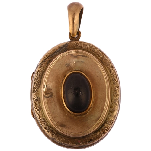 1141 - A Victorian garnet locket pendant, circa 1890, unmarked yellow metal settings with central oval cabo... 