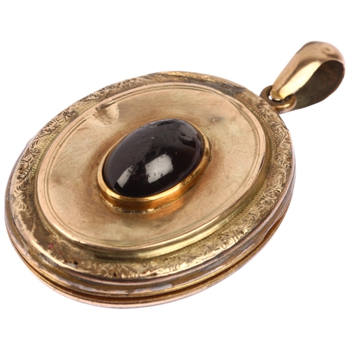 1141 - A Victorian garnet locket pendant, circa 1890, unmarked yellow metal settings with central oval cabo... 