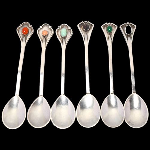 1688 - A set of 6 Arts and Crafts silver gem set teaspoons, shaped terminals with planished bowls, apparent... 