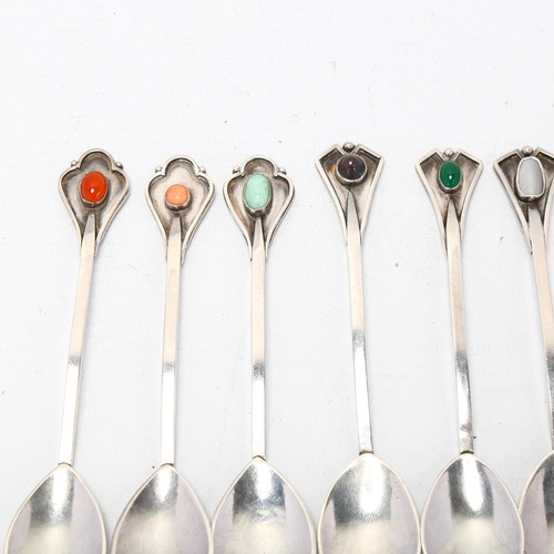 1688 - A set of 6 Arts and Crafts silver gem set teaspoons, shaped terminals with planished bowls, apparent... 