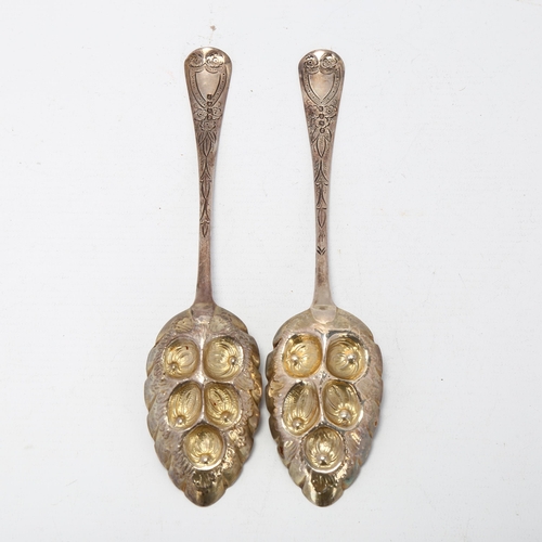 1696 - A pair of George III silver Old English pattern berry spoons, maker ID, London 1813, relief embossed... 