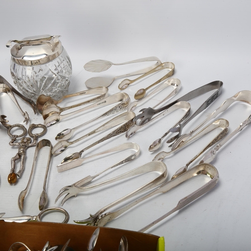 1707 - WITHDRAWN - A large quantity of silver plated sugar tongs and flatware, including novelty jester exa... 