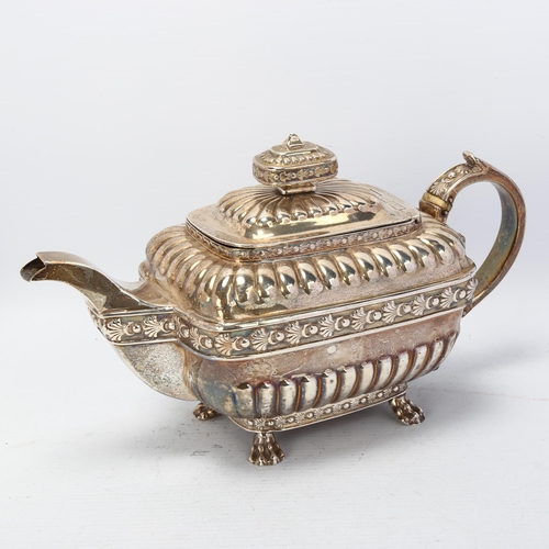 1746 - A George III silver teapot, indistinct maker, London 1812, bulbous rectangular form, with relief emb... 