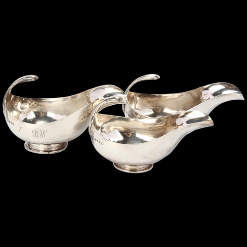 1748 - HARRODS - a graduated set of 3 George V silver sauce boats, London 1934, stylised form with floating... 