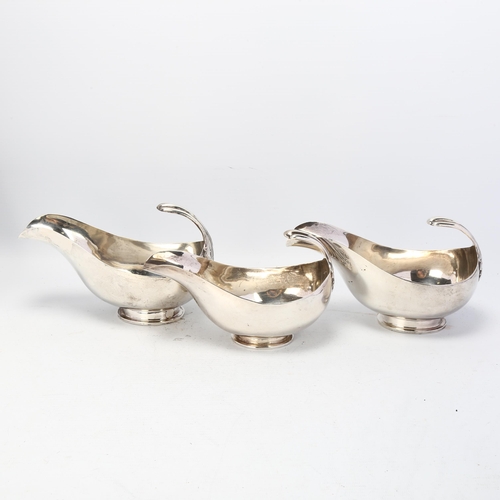 1748 - HARRODS - a graduated set of 3 George V silver sauce boats, London 1934, stylised form with floating... 