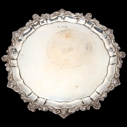 1752 - A George V silver salver, Atkin Brothers, Sheffield 1925, circular scalloped form with cast shell pi... 