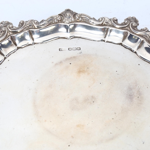 1752 - A George V silver salver, Atkin Brothers, Sheffield 1925, circular scalloped form with cast shell pi... 