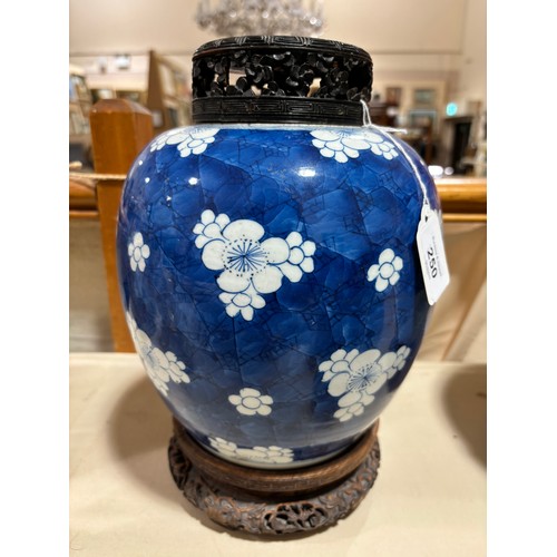 250 - A Chinese blue and white porcelain ginger jar, with blossom decoration, carved and pierced hardwood ... 