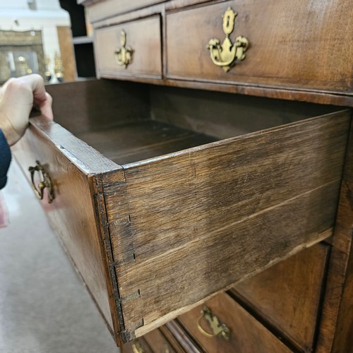 4 - A 19th century walnut chest on chest, feather-banded drawer fronts with brushing slide, brass drop h... 