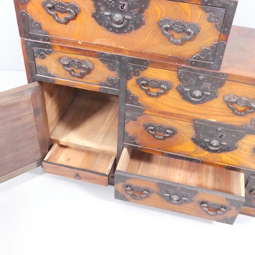 2011 - A Japanese two section Kaiden Tansu step chest of eight drawers with single cupboard. 127x120.5x40cm... 